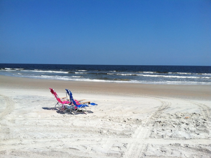 2 beach chairs on the beach shore